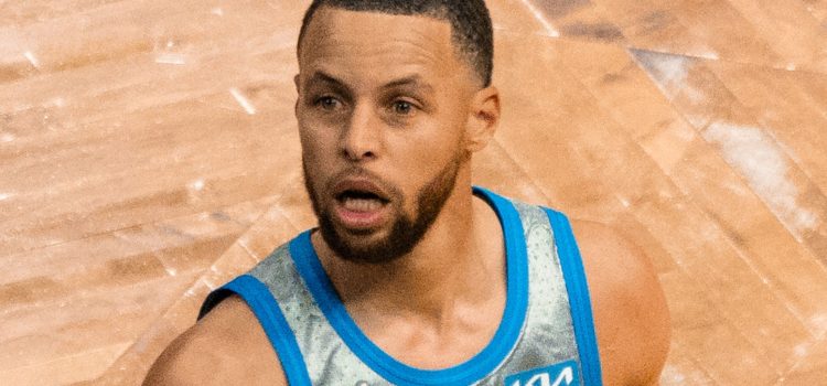Stephen Curry with his mouth open on the basketball court.