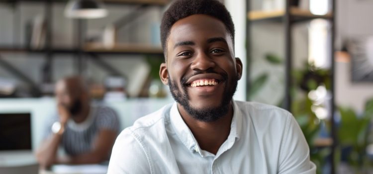 An employee smiling and having a good attitude at work.