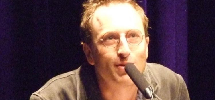 Journalist Jon Ronson talking into a microphone