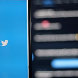 A phone screen showing the Twitter logo.
