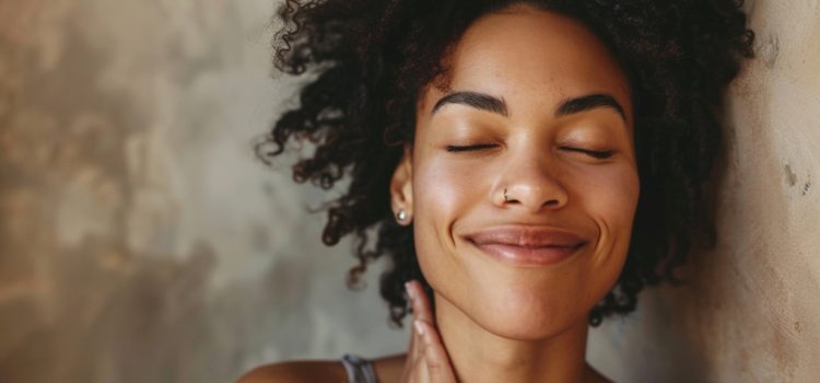 a smiling woman—with eyes closed and embracing herself—illustrates the power of self-love