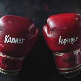 Two boxing mitts with names on them that read Kanner and Asperger