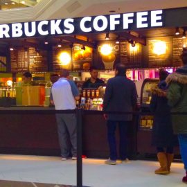 Employees serving people as part of the customer experience at Starbucks