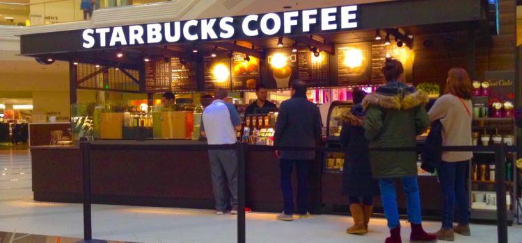 Employees serving people as part of the customer experience at Starbucks