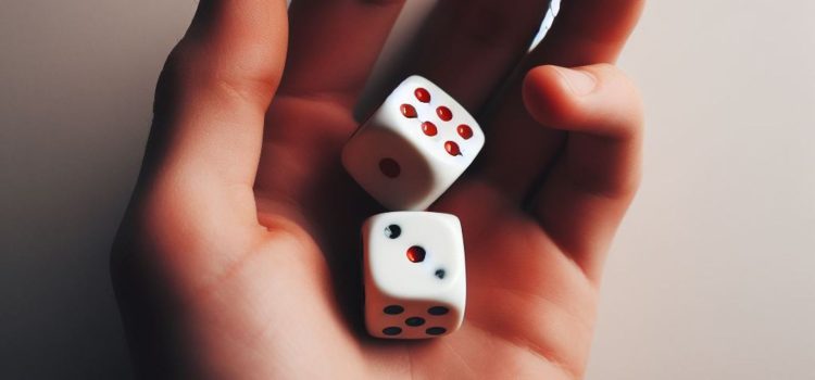 A person holding a pair of dice in their hand illustrates quantum indeterminacy and free will