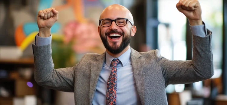 A happy manager in his office using a brand personality for the company