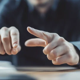 A man practicing lucid dreaming reality-checking by touching two fingers together