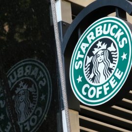 A Starbucks sign that represents Starbucks's business model