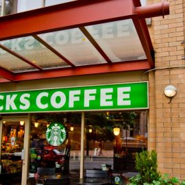 A Starbucks coffee store on the corner of a street