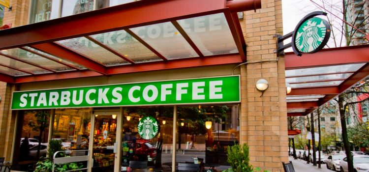 A Starbucks coffee store on the corner of a street