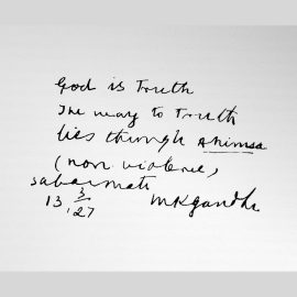 Gandhi writing "God is Truth. The way to Truth lies through Ahimsa (non-violence). Sabarmati, 13 March 1927, M. K. Gandhi"