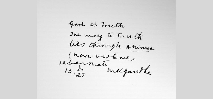 Gandhi writing "God is Truth. The way to Truth lies through Ahimsa (non-violence). Sabarmati, 13 March 1927, M. K. Gandhi"