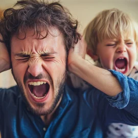 A dad holding his ears from a parenting trigger: his child screaming in his ear