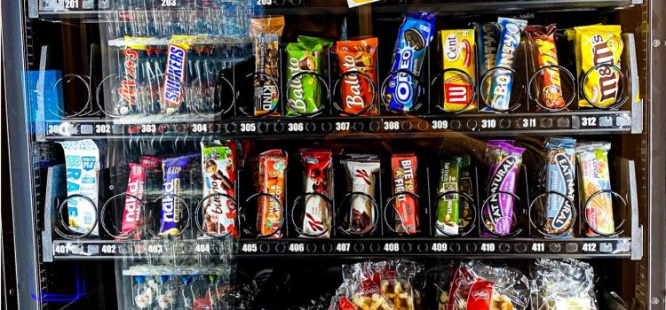 A vending machine full of addictive, ultra-processed junk food, such as chips and chocolate bars