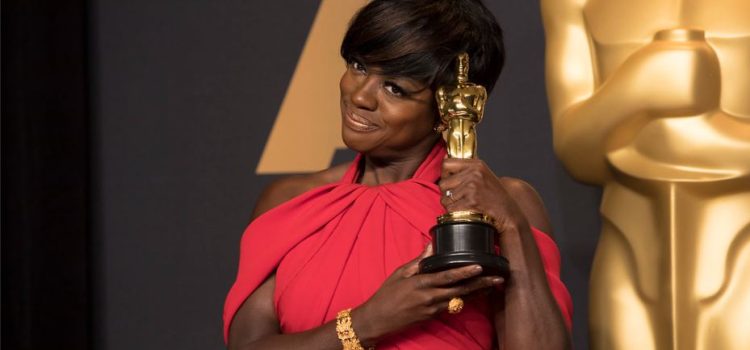 Viola Davis holding an Oscar award trophy