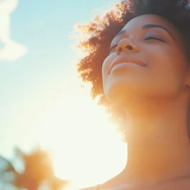 A woman feeling sunlight hormones with her eyes closed outside