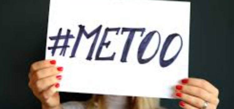 A woman holding up a sign that reads "#MeToo," showing the impact of me too movement