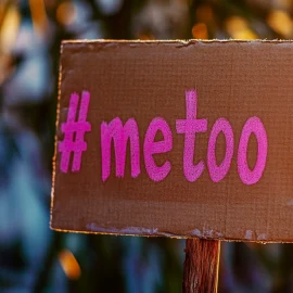 A cardboard sign that says "#metoo" in pink letters, showing when the me too movement became popular