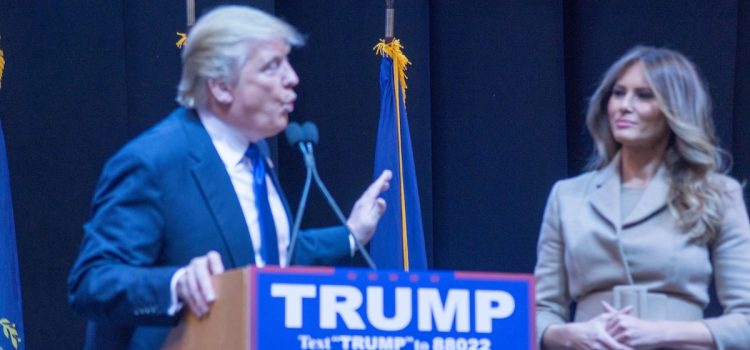 Donald Trump speaks at a presidential campaign event in New Hampshire on February 8, 2016, with Melania Trump