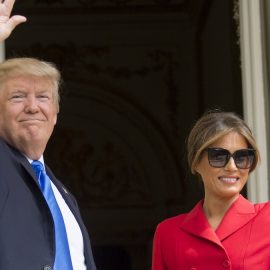 President Donald Trump and First Lady Melania Trump smiling and waving in 2017 photograph