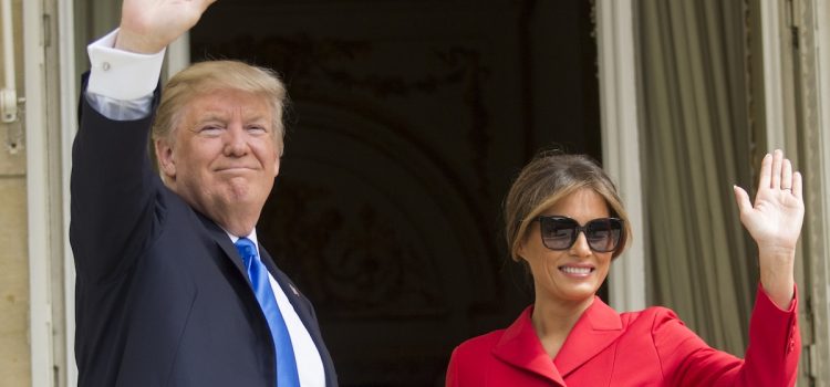 President Donald Trump and First Lady Melania Trump smiling and waving in 2017 photograph