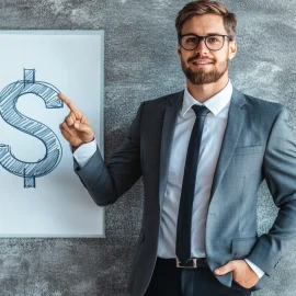 A businessman pointing to a dollar sign on a whiteboard, talking about the types of business cycles in economics