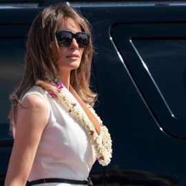 Melania Trump with a flower lei around her neck