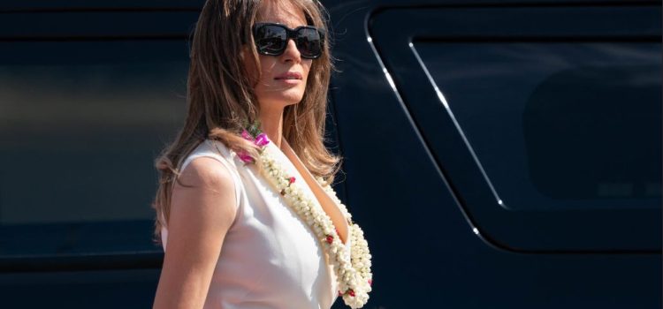 Melania Trump with a flower lei around her neck