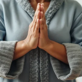 A woman wearing a light blue fleece clasping her hands together in prayer illustrates how to achieve inner peace