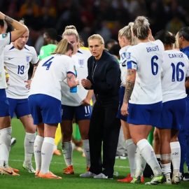 Head coach Sarina Wiegman talking to the England national women's football team on the field