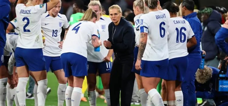 Head coach Sarina Wiegman talking to the England national women's football team on the field