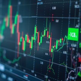 A person wearing glasses looking at a digital stock market chart illustrates stock picking vs. index funds