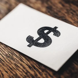 A dollar sign on white paper representing an income statement in business