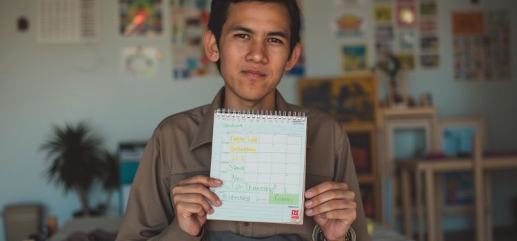 A man holding a written schedule illustrates positive self-pressure