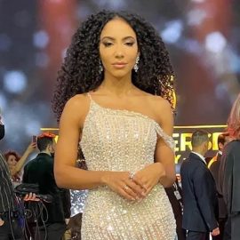 Cheslie Kryst in an cream-colored evening gown