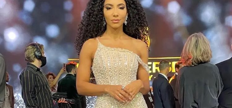 Cheslie Kryst in an cream-colored evening gown