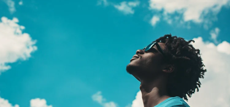 A man wondering what the human condition means, looking up at the sky