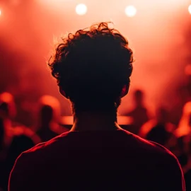 A nervous person in a crowd feeling the disadvantages of power as they look at an audience