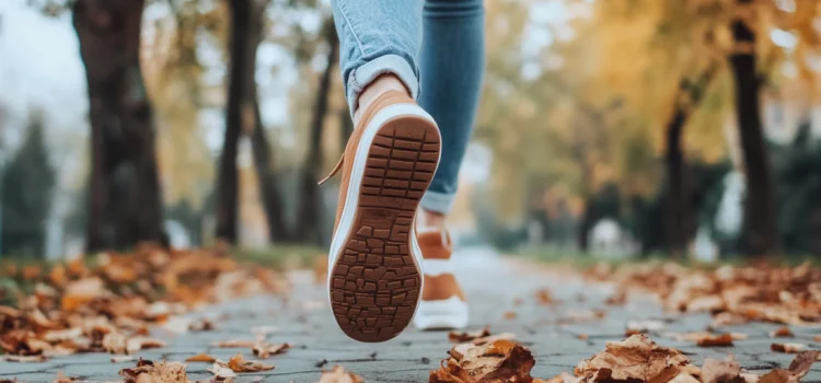 A person running on a sidewalk in nature, learning how to build momentum