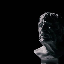 A bust of the Stoic philosopher Seneca against a black background