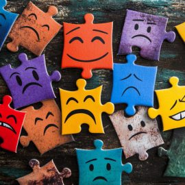 A jigsaw puzzle of various feelings and facial expressions illustrates how emotions are created