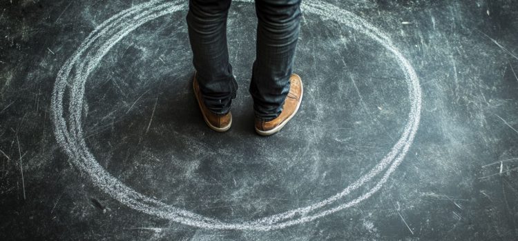 Feet standing in a drawn chalk circle on the ground, promoting expanding your creative zone