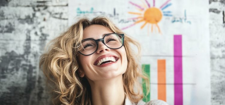 A smiling woman standing in front of an increasing bar chart illustrates business growth methods